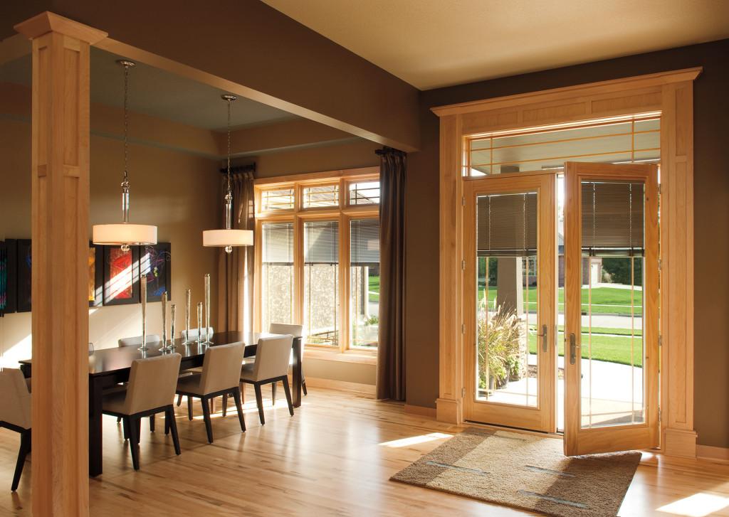 Warm wood casement windows and a full-light patio door